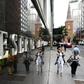 Pedestrians reflected in the wall of the Reserve Bank of Australia on Tuesday after the government unveiled a big-spending federal budget