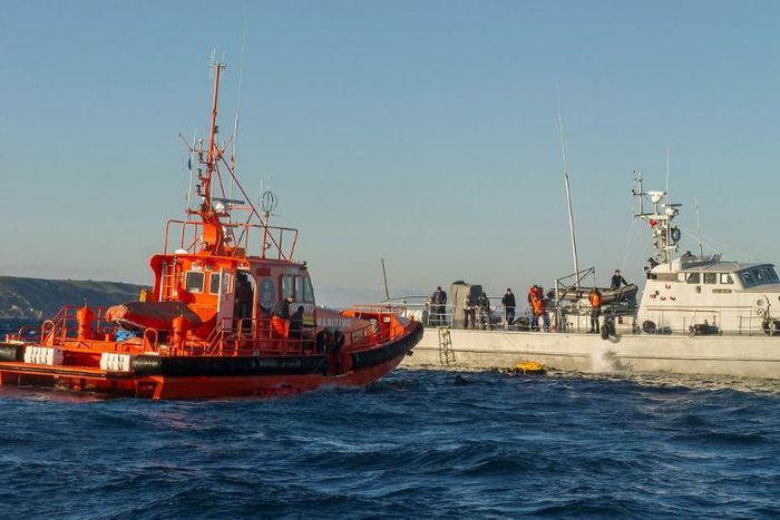 Sailors with the Spanish emergency services (L) and the Moroccan Navy rescue would-be immigrants in the Straits of Gibraltar in December 2012