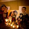 A woman (pictured February 2019) places candles next to a memorial for journalist Jan Kuciak and his fance Martina Kusnirova, who were gunned down in their home in February 2018