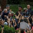 Brazilian former president (2003-2011) Luiz Inacio Lula da Silva (C-waving) is escorted by security forces upon arrival at Jardim da Colina cemetery to attend the funeral of his grandson on March 2, 2019