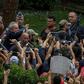 Brazilian former president (2003-2011) Luiz Inacio Lula da Silva (C-waving) is escorted by security forces upon arrival at Jardim da Colina cemetery to attend the funeral of his grandson on March 2, 2019