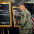 A US solider shows a picture of Ali Mussa Daqduq during a July 2007 press conference in Baghdad