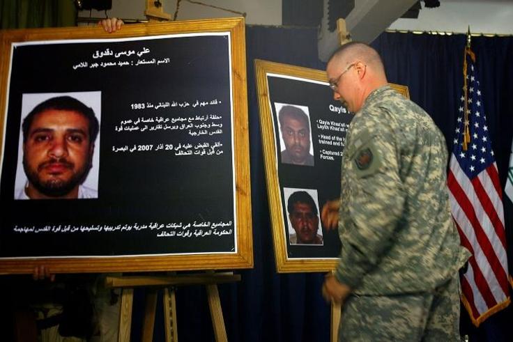 A US solider shows a picture of Ali Mussa Daqduq during a July 2007 press conference in Baghdad