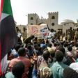 Protesters gather in front of soldiers during a rally demanding a civilian body to lead the transition to democracy, outside the army headquarters in the Sudanese capital Khartoum on April 12, 2019