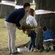 New Zealanders lay flowers near one of the mosques targeted in Friday's deadly attack