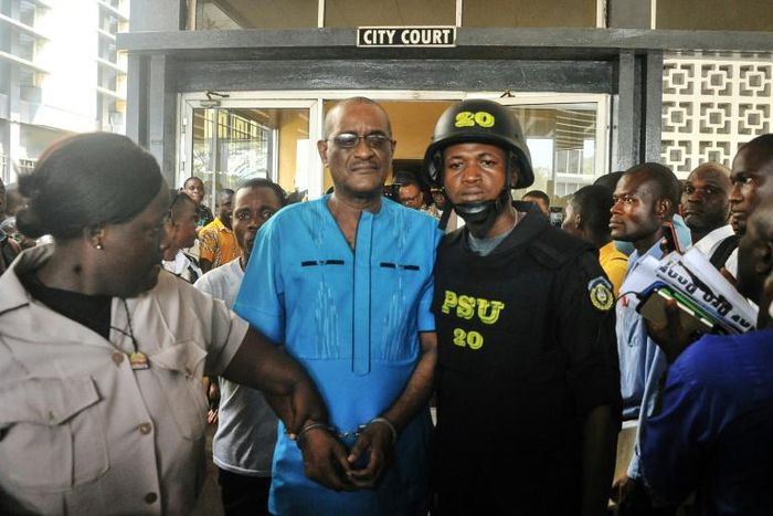 Former deputy governor of the Central Bank of Liberia Charles Sirleaf (C) has been charged with criminal conspiracy over the handling of billions of Liberian dollars in a banknote printing scandal