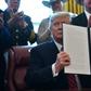 US President Donald Trump displays his veto, which overrides congressional opposition to his declaration of a national emergency at the Mexican border