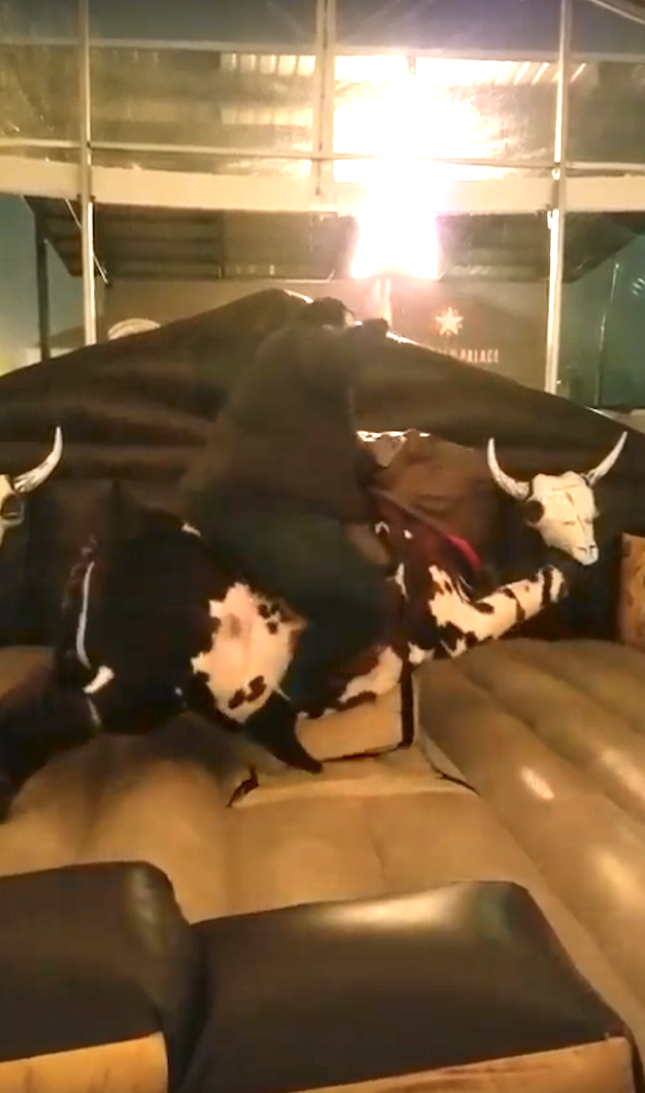 Ismail riding a mechanical bull at 380 lbs.