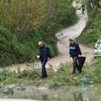 Murataj, armed with an automatic rifle and a grenade, was killed in a shootout with the police on a nearby road. Here, police are shown combing the area for clues