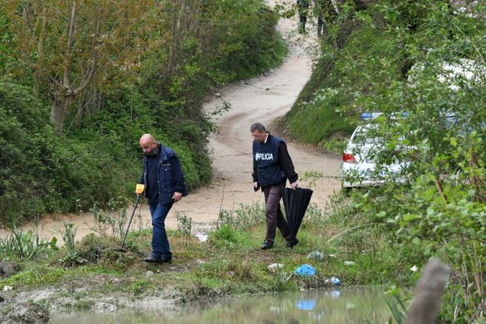 Murataj, armed with an automatic rifle and a grenade, was killed in a shootout with the police on a nearby road. Here, police are shown combing the area for clues