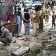 Pakistani security officials inspect the site of a bomb blast at a fruit market in Quetta