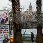 People walk past election banners of Turkish President Tayyip Erdogan and AK Party's mayoral candidate for Istanbul, Binali Yildirim, in Istanbul