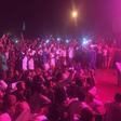 Nighttime protesters chant slogans against Sudan's government in front of the army headquarters
