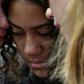 Residents shed tears after leaving flowers in tribute to victims of the New Zealand massacre, two days after a mass shooting at two mosques in the southern city of Christchurch