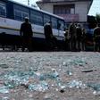 Indian police inspect the site of a grenade blast at a bus station in Jammu
