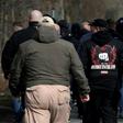 The silent, mostly male crowd lined the road leading to a cemetery for the funeral of Thomas Haller, the co-founder of a group called "HooNaRa" (Hooligans-Nazis-Racists)