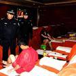 Chinese police checking a public bath house as masseurs serve their guests in Qingdao, east China's Shandong province.