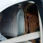 French tourist Arthur Desclaux covers his face while leaving in a police car after a court appearance in Naypyidaw. On Wednesday he was been sentenced to one month in prison with hard labour for attempting to fly a drone near Myanmar's parliament