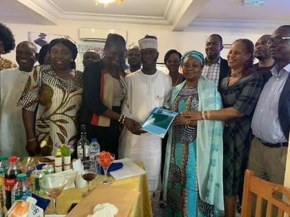 Adedayo Thomas,Executive Director, NFVCB receiving a Five-year Strategic Plan document from his Directors at at an event to mark his two years in office in Abuja [nan]