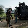 Police officers stand guard outside an election collection centre in Port Harcourt after Nigeria's presidental election