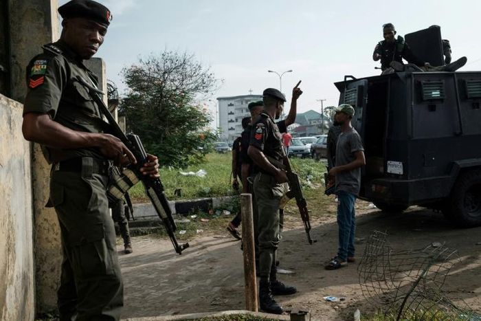 Police officers stand guard outside an election collection centre in Port Harcourt after Nigeria's presidental election