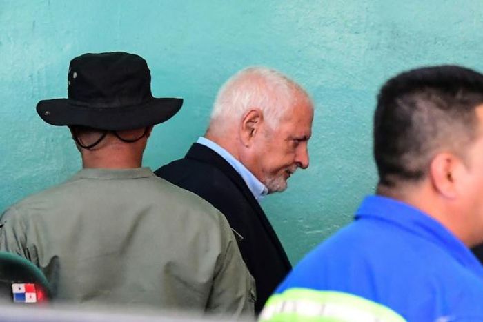 Panama's former president (2009-2014) Ricardo Martinelli (C), is escorted by police officers as he leaves the court where he was attending a hearing over wiretapping allegations
