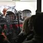 Police stand guard after protestors burst into state-run RTS televsion