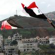 Syrian national flags are flown in a town across from the Israeli-annexed Golan Heights a day after President Donald Trump signed a proclamation declaring US recognition of the Golan as Israeli territory