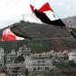 Syrian national flags are flown in a town across from the Israeli-annexed Golan Heights a day after President Donald Trump signed a proclamation declaring US recognition of the Golan as Israeli territory