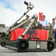 Canadian Prime Minister Justin Trudeau observes a military robot as he meets with Latvian, Canadian and other NATO soldiers in Adazi, Latvia, in July 2018
