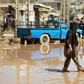 An Iranian woman walks through a flooded street in the city of Poldokhtar (pictured April 2, 2019) as the flood death toll reaches 70 people