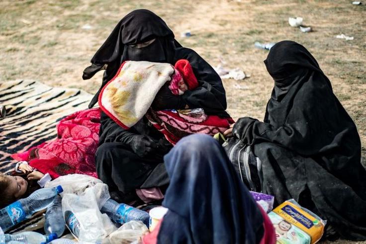 Dorothee Maquere, wife of French jihadist Jean-Michel Clain, sits with four of her five children at a screening area on Tuesday