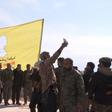 US-backed Syrian Democratic Forces raise their flag on a building in the jihadists final bastion, celebrating the end of the Islamic State group's brutal caliphate