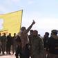 US-backed Syrian Democratic Forces raise their flag on a building in the jihadists final bastion, celebrating the end of the Islamic State group's brutal caliphate