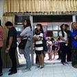 People queue up to cast their ballot during early voting in Bangkok on Sunday