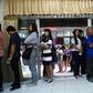People queue up to cast their ballot during early voting in Bangkok on Sunday