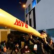 A supporter of Moshe Feiglin, leader of the far-right Zehout party, smokes a fake inflatable marijuana joint at a rally in the Israeli city of Tel Aviv on April 2, 2019
