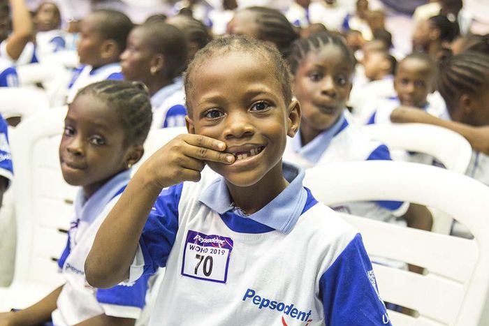 A pupil settles for the brush day and night pose at the Pepsodent 2019 World Oral Health Day celebration.