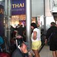 Stranded passengers wait outside the Thai Airways ticket counter at Suvarnabhumi International Airport in Bangkok after the airline cancelled 11 European-bound flights due to Pakistan closing its airspace amid mounting tensions with India