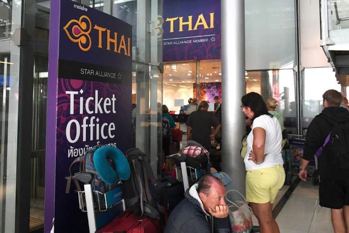 Stranded passengers wait outside the Thai Airways ticket counter at Suvarnabhumi International Airport in Bangkok after the airline cancelled 11 European-bound flights due to Pakistan closing its airspace amid mounting tensions with India