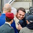 Brazilian President Jair Bolsonaro (C), seen here being embraced by Israeli Prime Minister Benjamin Netanyahu, is in Israel on a visit while at home protesters marched against his government