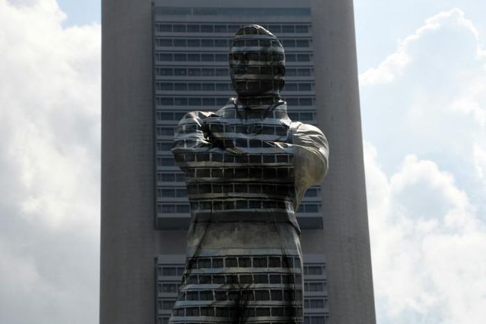 The statue of Sir Stamford Raffles is painted on one side to blend into the background building to commemorate the Singapore Bicentennial marking the 200th anniversary of the British arriving in Singapore