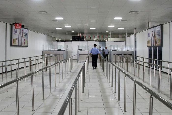 A Libyan policeman walks in the empty Mitiga International Airport in September last year, when the facility was closed by an earlier round of militia clashes