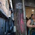 Homemaker Kelly Cristina Pereira da Silva, whose son was killed by stray bullets, poses with her son's photo outside her house in the Manguinhos favela or shantytown in Rio de Janeiro, Brazil, on October 10, 2017