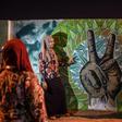 Once-grey walls near the military headquarters are painted with large clenched fists and victory signs symbolic of the popular uprising