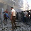 A man evacuates a young casualty following a reported air strike by regime forces and their allies in the jihadist-held Syrian town of Maaret Al-Numan in Idlib province on Sunday