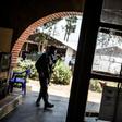 A police officer stands guard beside a window full of bullet holes at an Ebola treatment centre in Butembo. Suspected Mai-Mai tribal militia raided the ETC and killed a policeman and wounded a health worker early in March