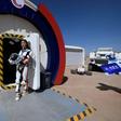 A guide wearing a space suit stands at an entrance to "Mars Base 1" in the Gobi desert in China