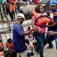 Rescued passengers are disembarked from a rescue vessel at the port of Santo Antonio on Principe after a passenger ship sank