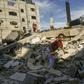 A Palestinian girl climbs on the remains of a building destroyed during an Israeli air strike on Rafah in the southern Gaza Strip on May 5, 2019